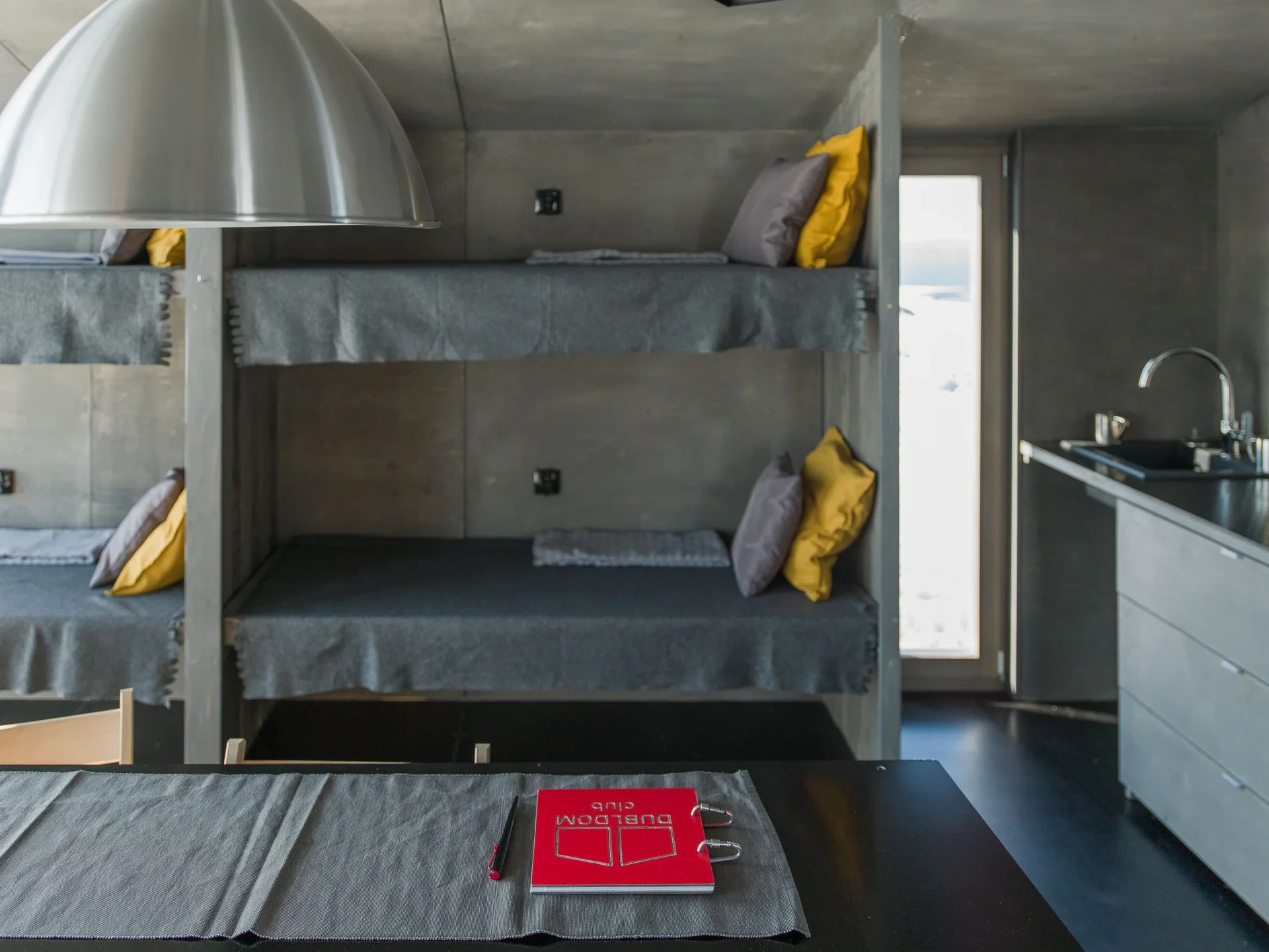 Bunk beds with yellow pillows and guestbook