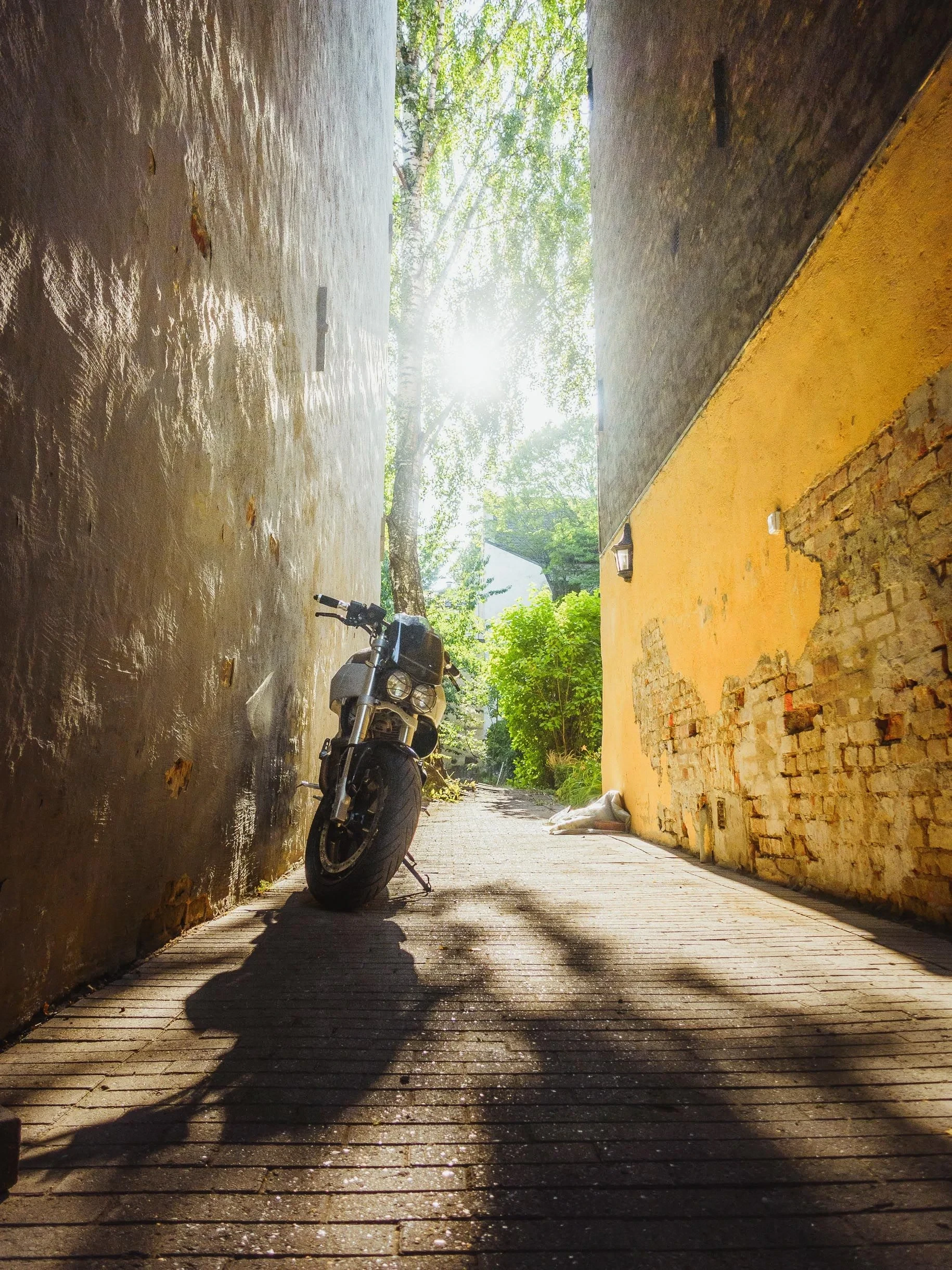 Motorcycle in a sunlit narrow alley