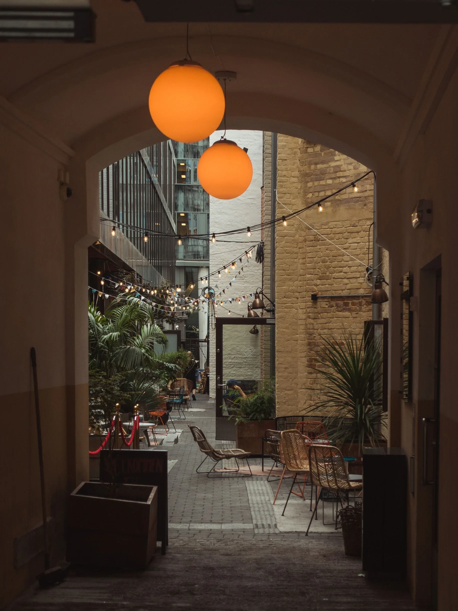 Cozy courtyard cafe with hanging lights