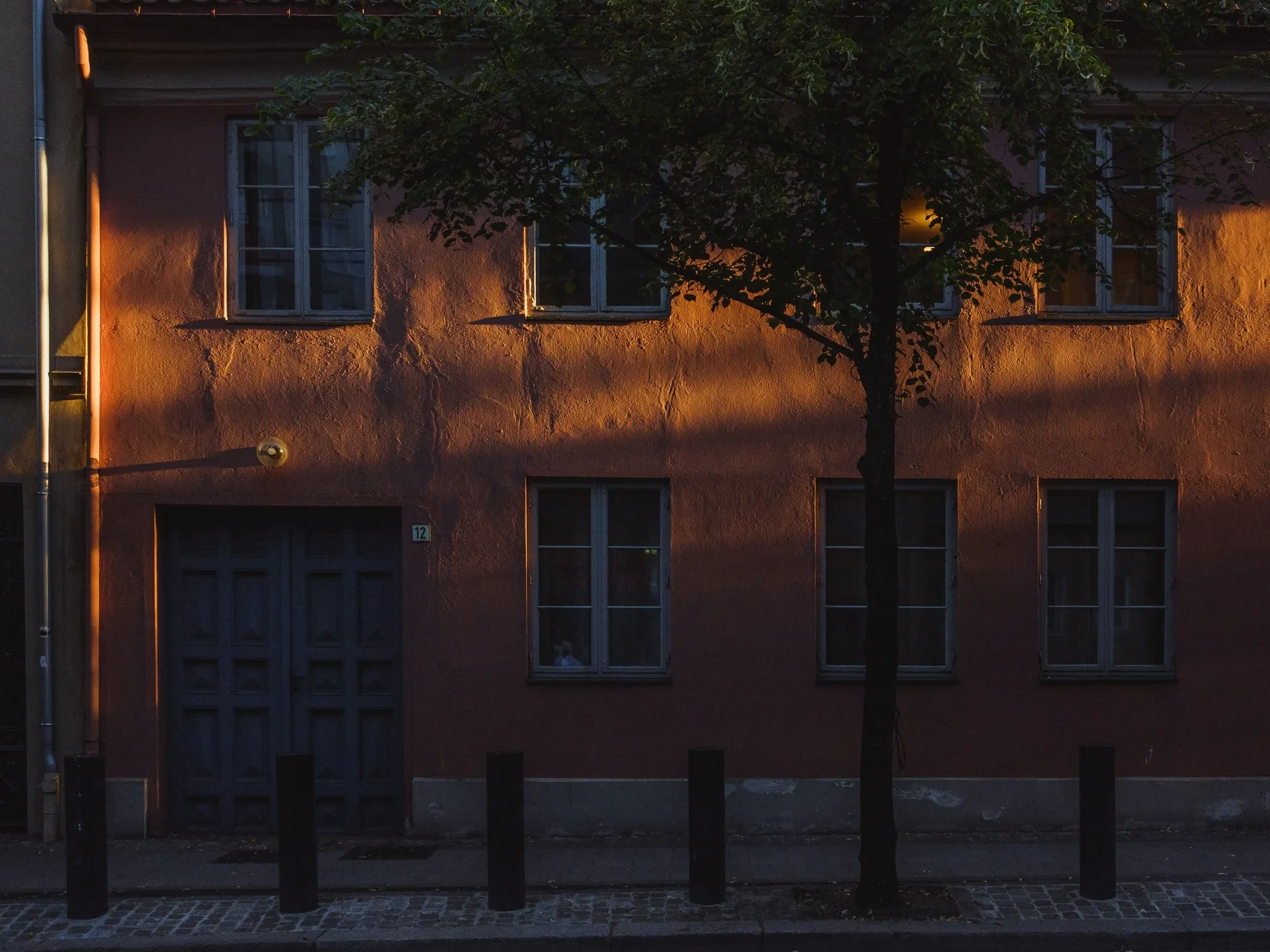 Warm sunset light on a red house facade