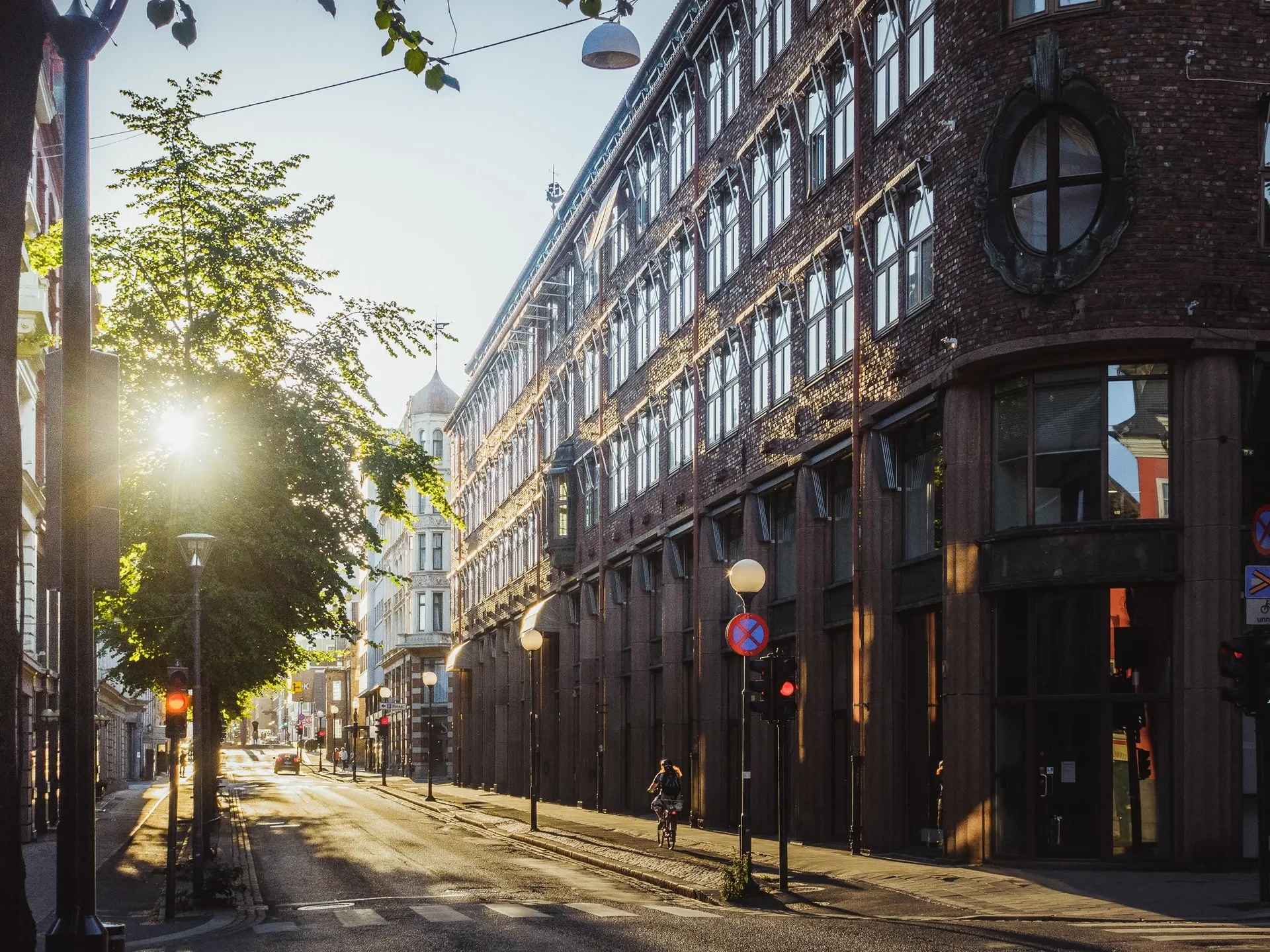 Sunlit street lined with brick buildings