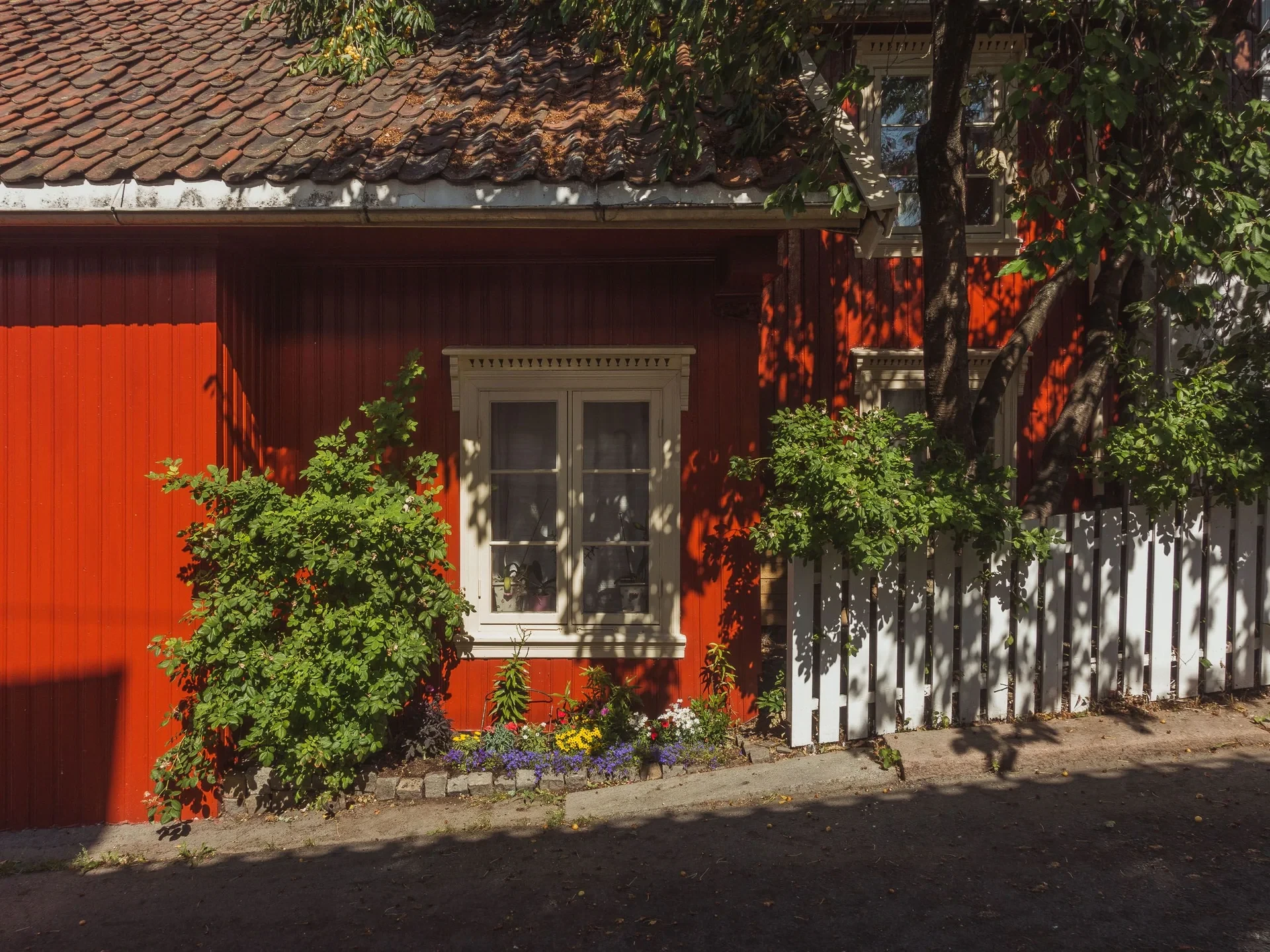 Red wooden house with white-framed window