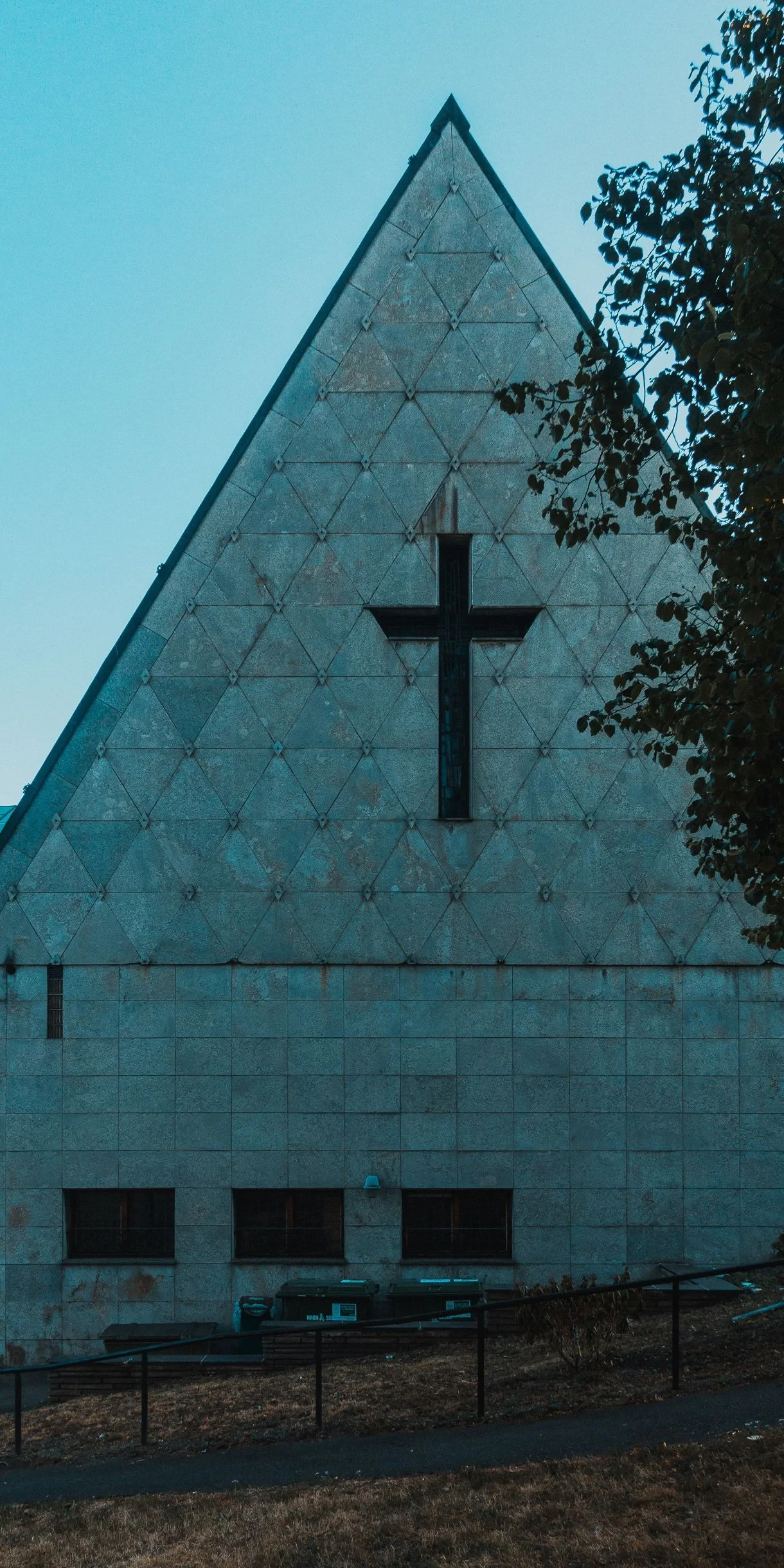 Triangular stone church gable with a cross